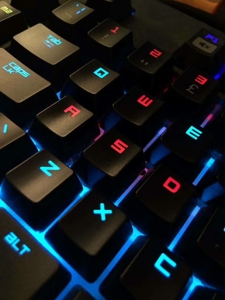 Neon-lit Marvel: Immersive Close-up of a Mechanical Computer Keyboard Set Against a Digital Realm Wallpaper