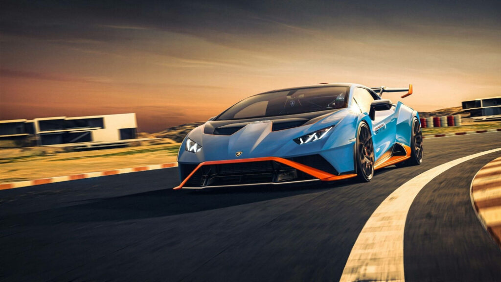 Neon Blue Beast: Lamborghini Aventador Roaring Across the Racetrack at Sunset Wallpaper