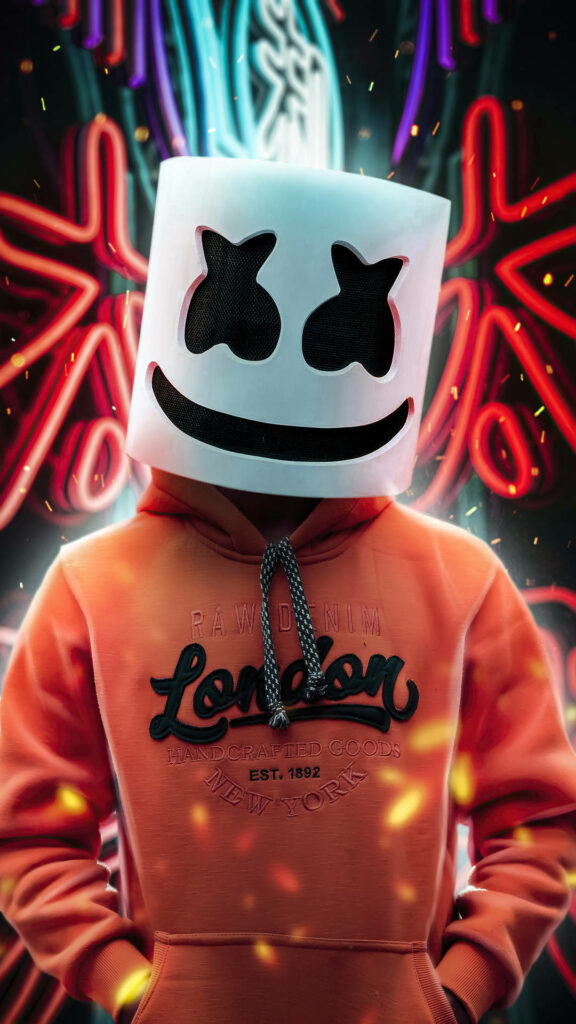 EDM Sensation Marshmello Strikes a Cool Pose Amidst Vibrant Neon Signs - A Must-Have iPhone Wallpaper!