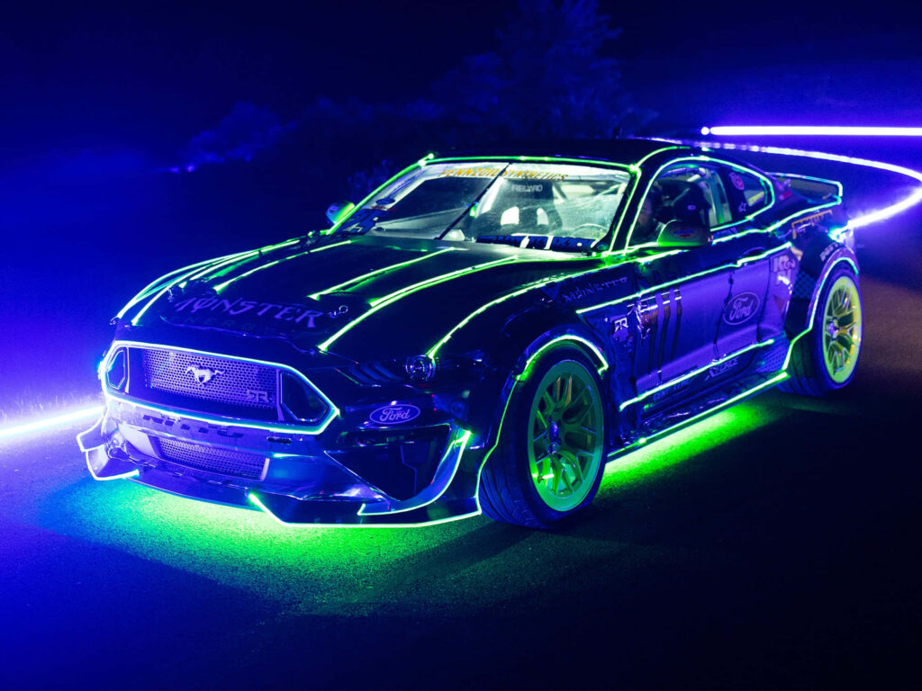 Neon green and blue outlined sleek sports car wallpaper futuristic high tech design on black background