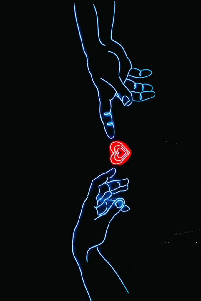 Vibrant Neon Wallpaper: Glowing Hands & Red Heart on Dark Background