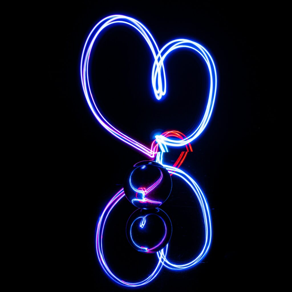 Neon Heart Wallpaper: Vibrant Light Trails and Reflective Glow Background