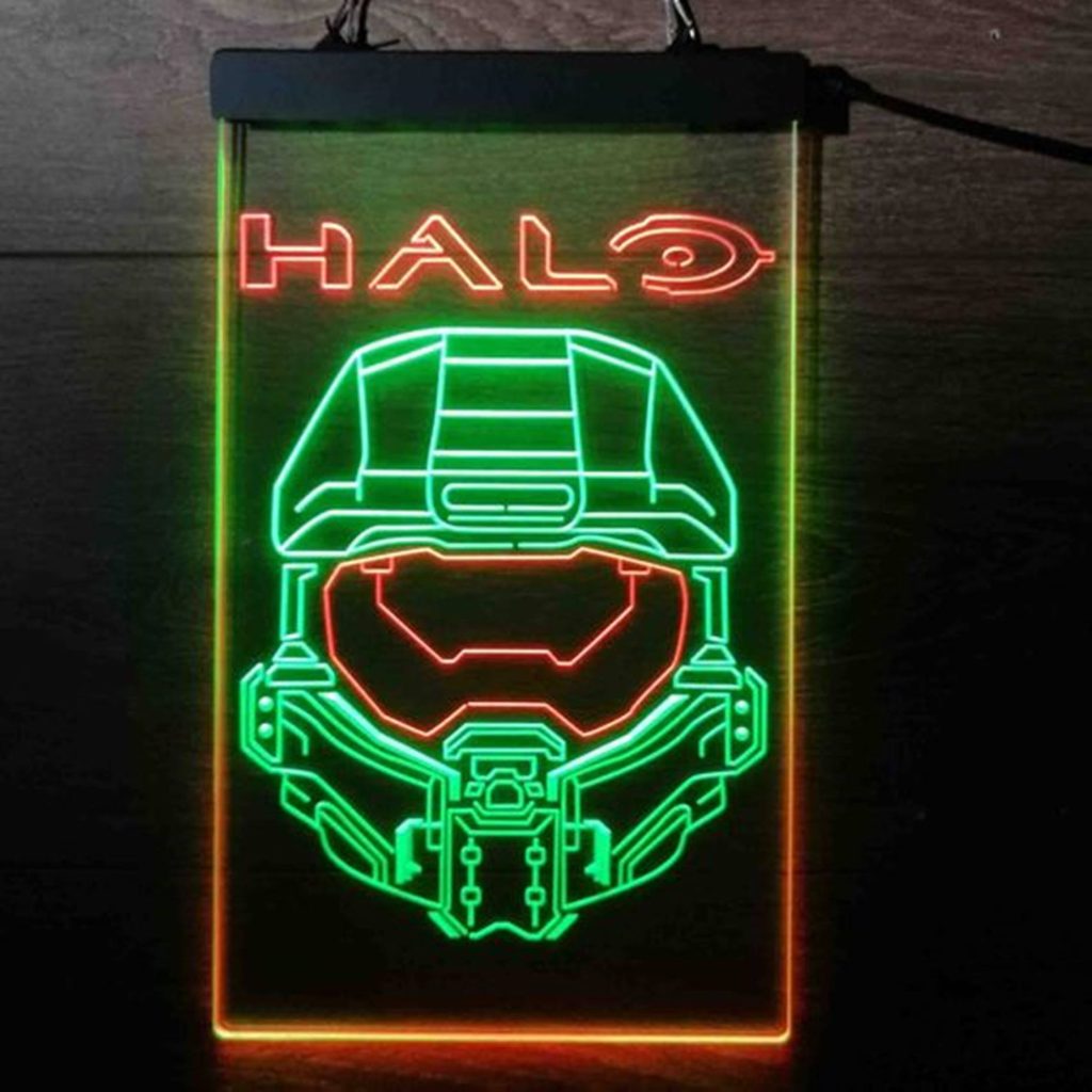 Neon LED Master Chief helmet sign glowing green and red on dark wood for gaming decor Wallpaper