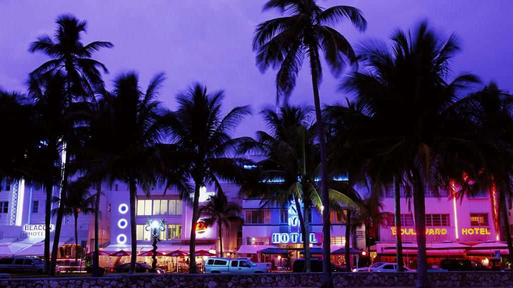 Glowing Nightscapes: Captivating Retro Miami's Art Deco Splendor Wallpaper
