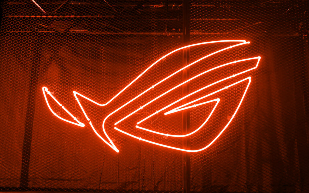 The Glowing Emblem of Power: An Asus Rog Logo Wallpaper in Neon Orange Aesthetic