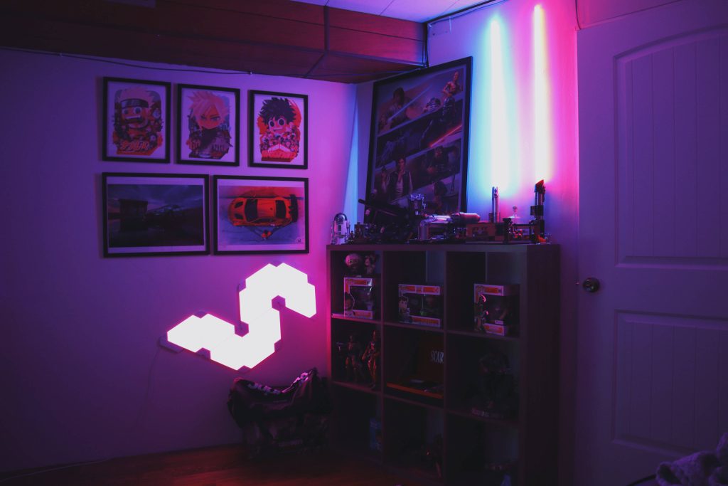 Neon purple gamer room wallpaper with Funko Pop shelf anime art and modular LED lights background