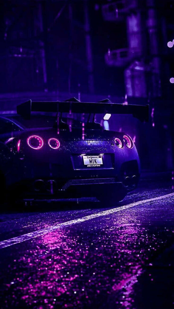 Neon purple Nissan R35 GTR with glowing taillights parked on wet city street at night wallpaper