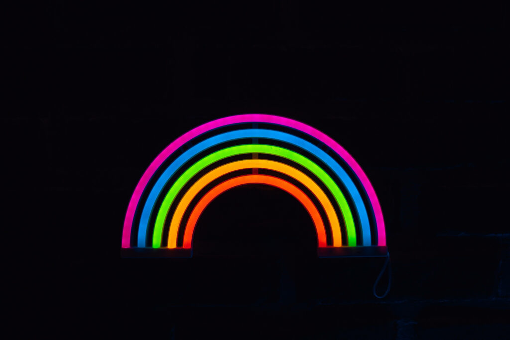 Glowing Spectra: A mesmerizing display of neon radiance, set against an enigmatic dark canvas Wallpaper