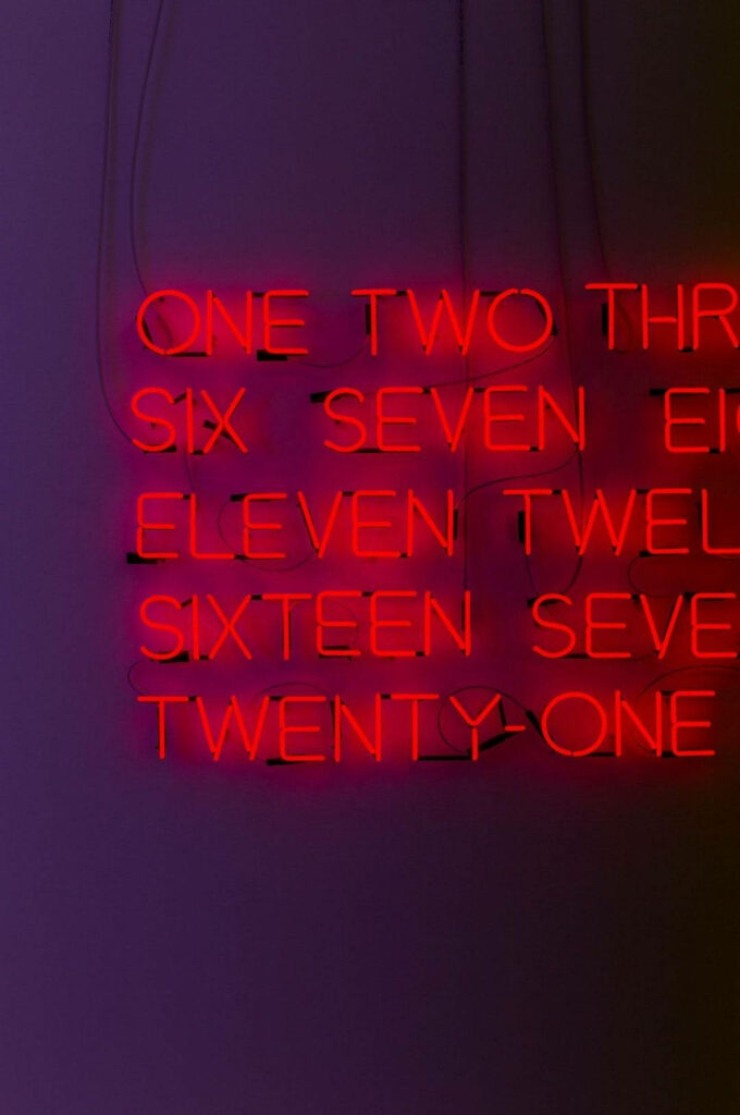 Fiery Neon Numbers: A Dazzling Red Baddie Wallpaper on a Mysterious Dark Purple Background