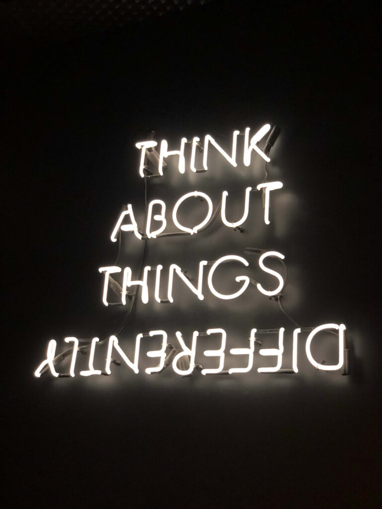Neon 'Think About Things Differently' Wallpaper for Creative Inspiration