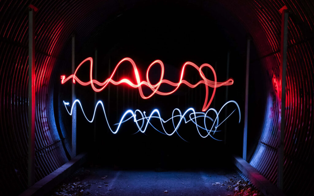 Neon Wavy Abstract Wallpaper: Vibrant Red & Blue Tunnel Background