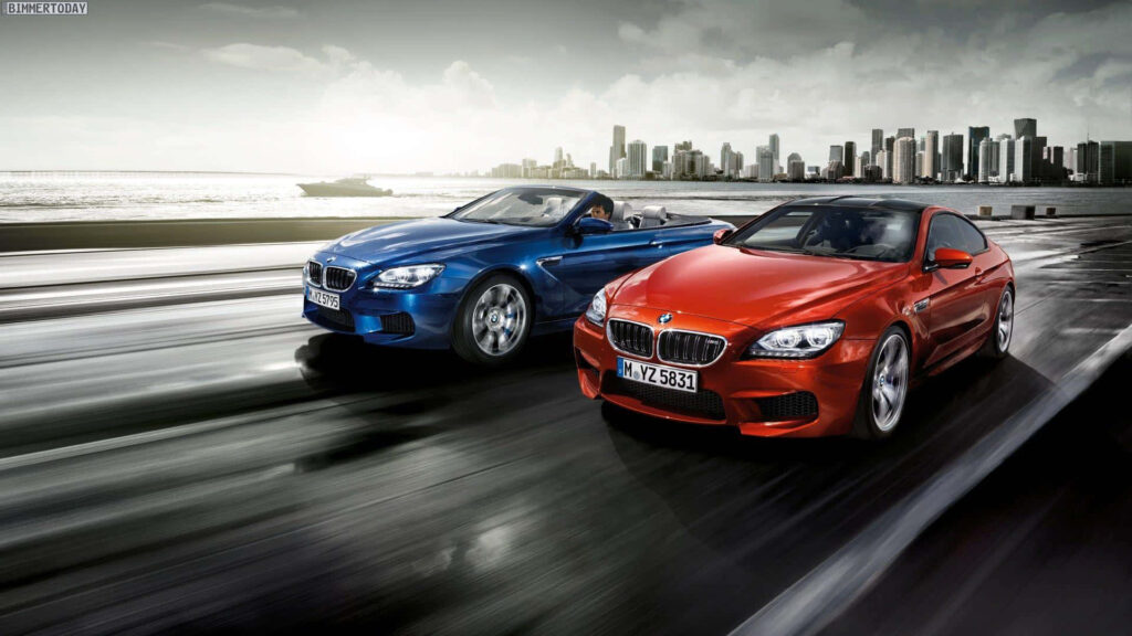 Blue and Red BMW M Series Cars on Road - Cityscape Background Wallpaper
