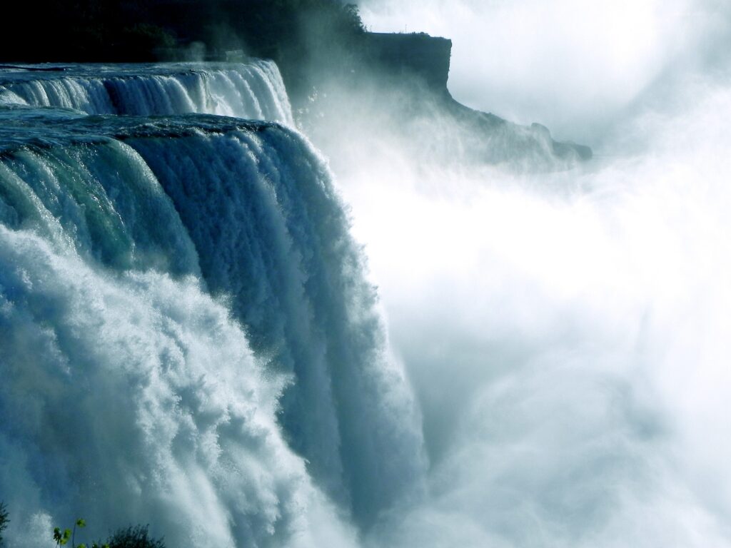 Niagara Falls waterfall cascading with mist and cliffs bold blue white hues nature wallpaper
