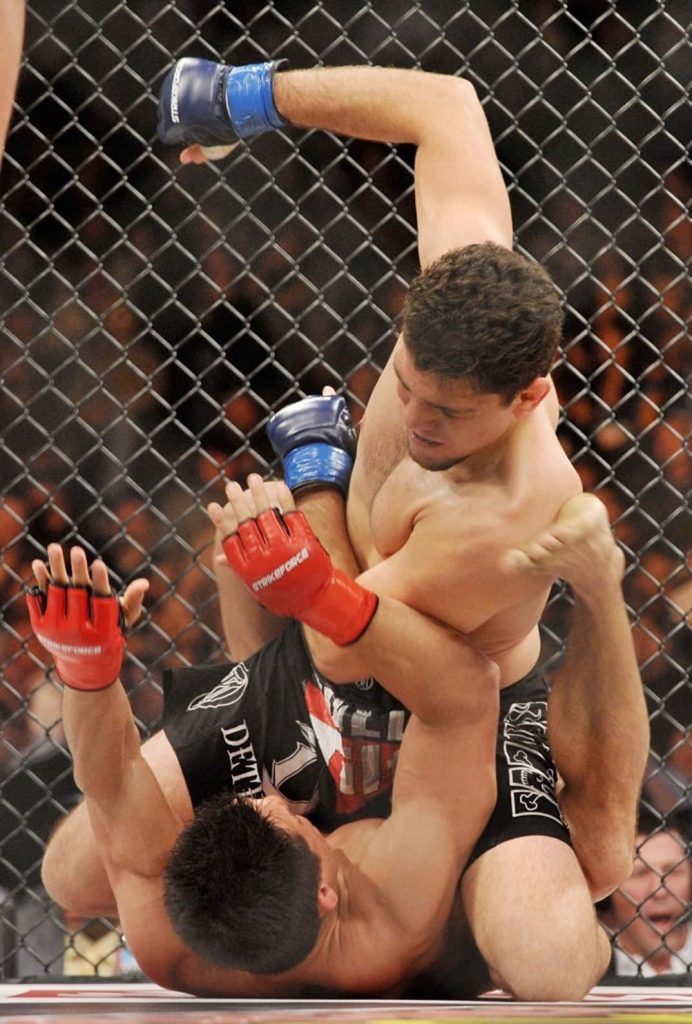 Nick Diaz grappling Frank Shamrock in Strikeforce MMA cage intense ground fight wallpaper