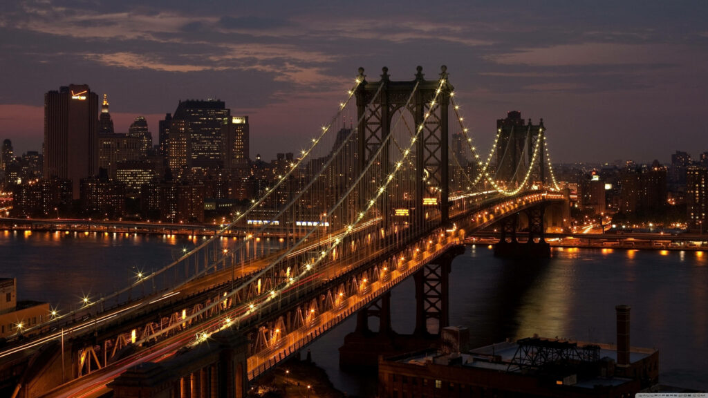 Glowing Manhattan Bridge: A Stunning Computer Wallpaper of New York City's Iconic Landmark At Night