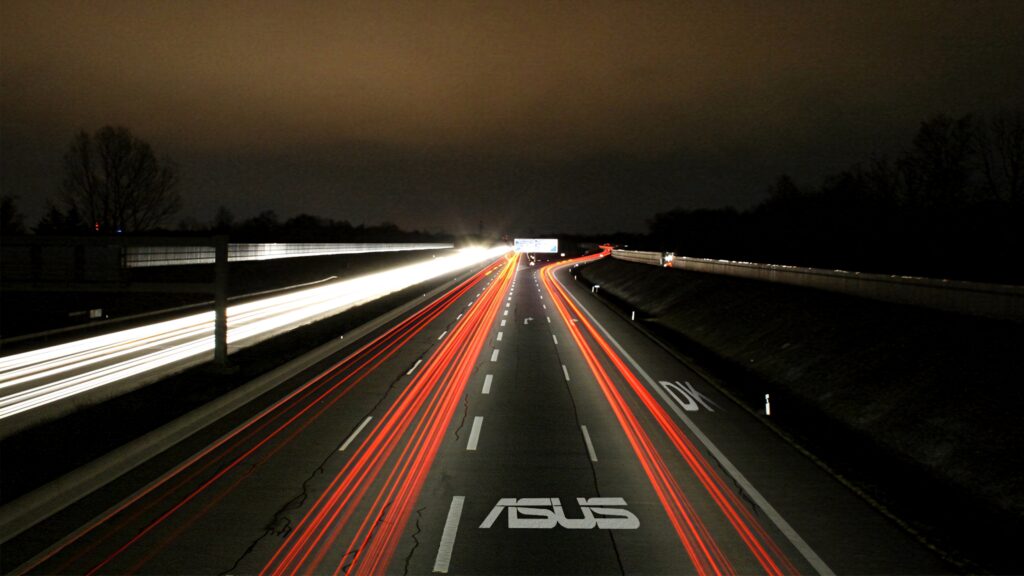 Night highway with red white light trails and ASUS logo on road futuristic wallpaper background