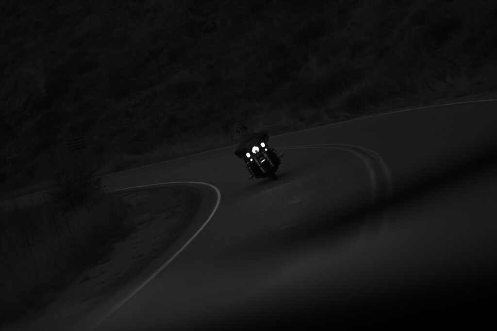 Motorcyclist Night Ride: Captivating Black-and-White Wallpaper