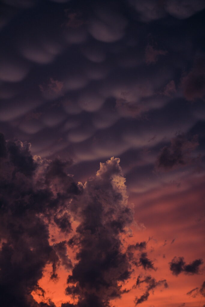 Dramatic Night Sky HD Wallpaper: Dark Clouds & Warm Orange Glow