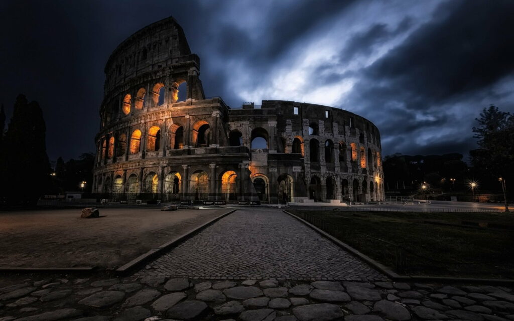 Rome's Iconic Colosseum Illuminated in the Night: Majestic Landmark HD Wallpaper