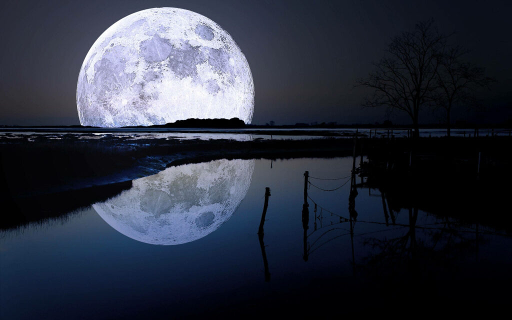 Enchanting Reflection: Mesmerizing Moon Casting its Radiance on a Serene Lake in Moonlit Background Wallpaper