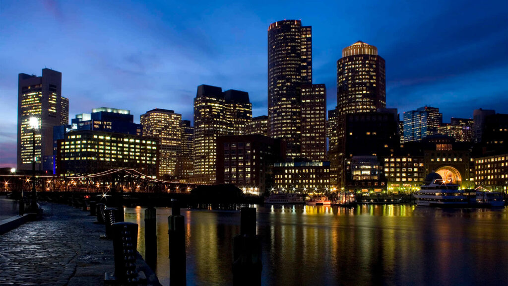 Vibrant Night Cityscape Wallpaper: Illuminated Skyscrapers & Water Reflections