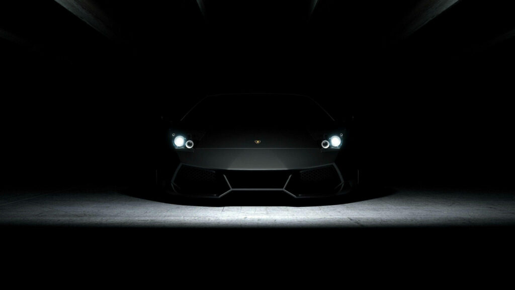 Enigmatic Elegance: Captivating 4K Image showcasing a Sleek Black Car with Illuminated Open Headlights against a Mysterious Dark Background Wallpaper