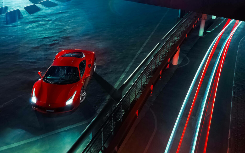 Nighttime Symphony: A Captivating Ferrari Encounter on a Serpentine Neon Course Wallpaper