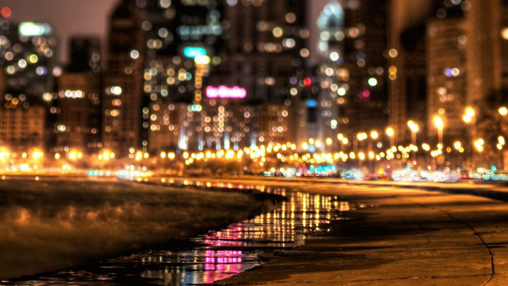 City night wallpaper with warm streetlights colorful bokeh reflections on wet urban path