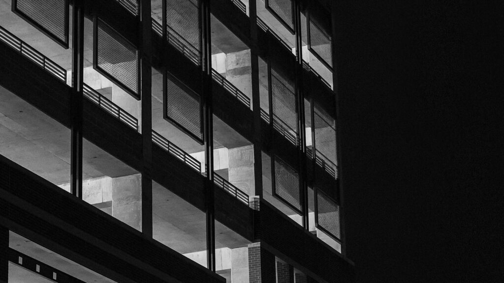 Midnight Monoliths: Impressive Building Windows Set Against a Black Aesthetic HD Wallpaper Background Photo