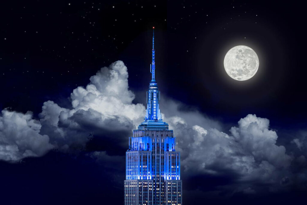Enchanting Nighttime Skies: Capturing the Empire State Building in Majestic Moonlit Splendor Wallpaper