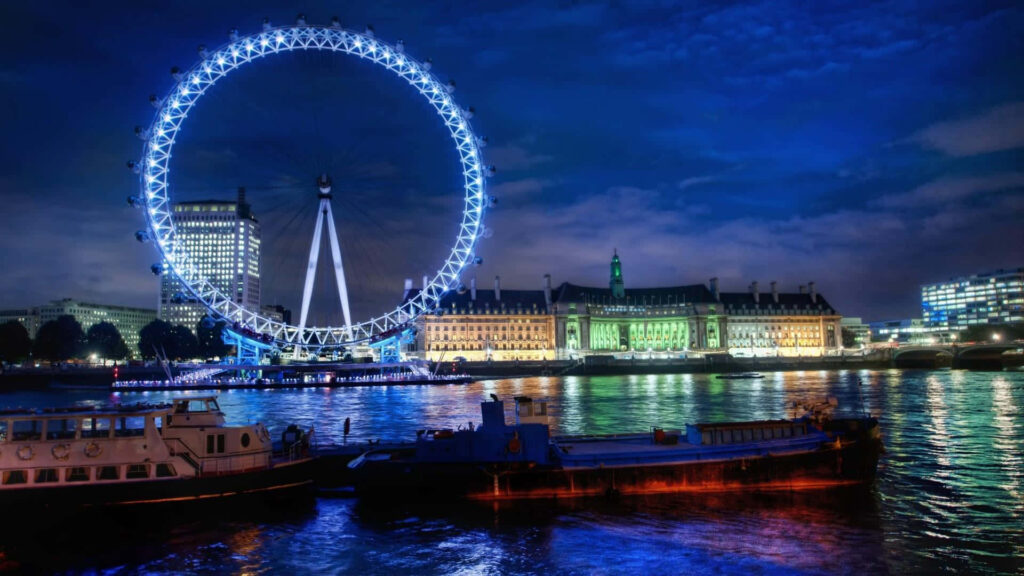 Gleaming Nights: A Stunning Wallpaper of London Eye Ferris Wheel in England