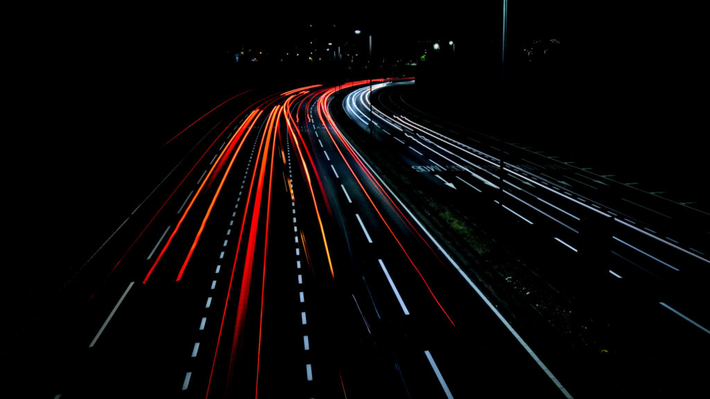 Nighttime Symphony: Mesmerizing Light Trails of Cars in Time-lapse Bliss Wallpaper