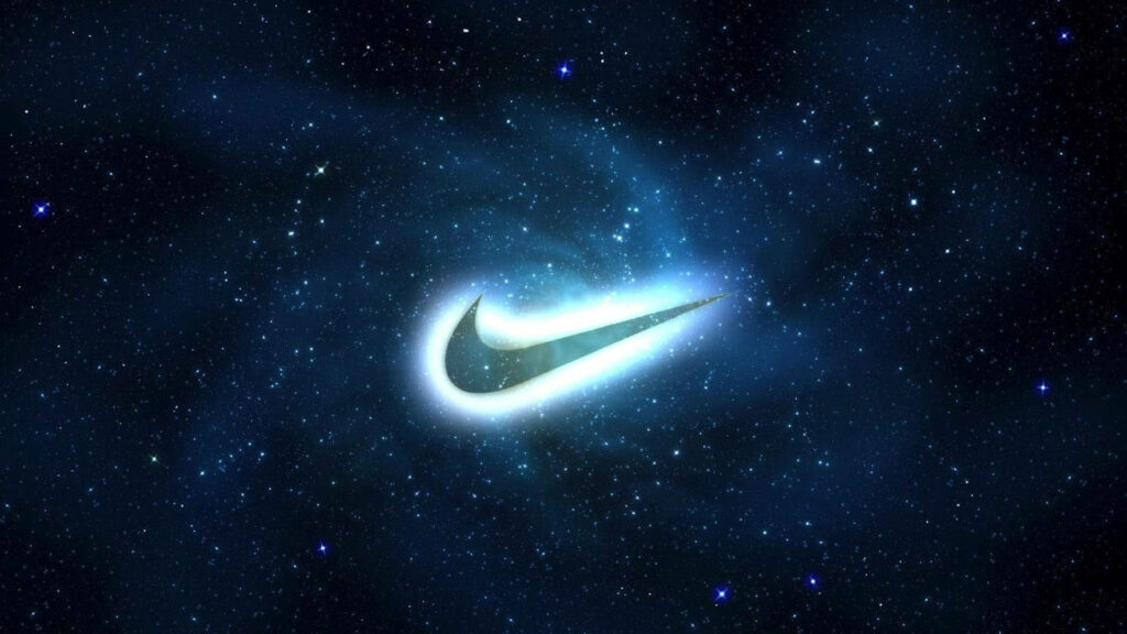Nike Swoosh glowing in cosmic galaxy with swirling energy and starry deep blue background wallpaper