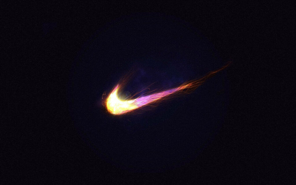 The Vibrant Nike Swoosh: A Striking Emblem Enveloped in Colorful Hues, Cast against a Mysterious Grainy Backdrop Wallpaper