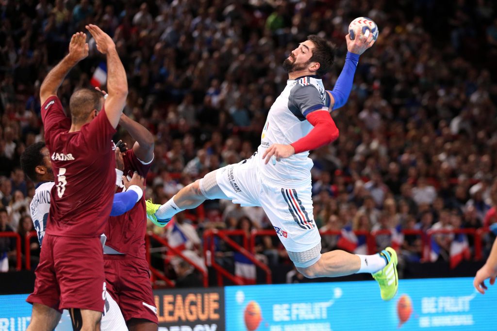 Nikola Karabatic jumps for a powerful handball shot France vs Qatar intense match action Wallpaper