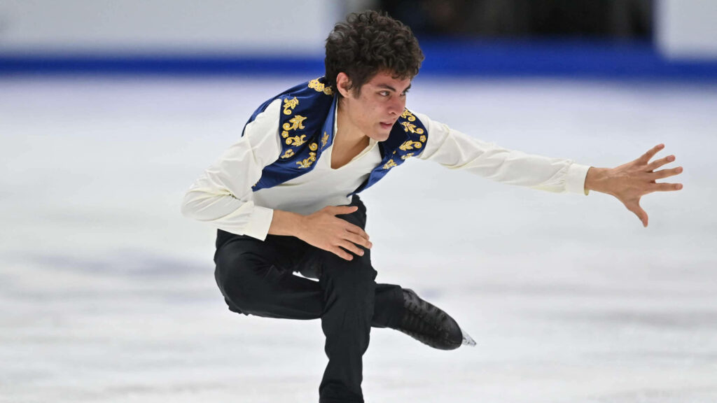 Italian figure skater Nikolaj Memola performs dynamic routine at Santa Claus Cup on ice rink Wallpaper