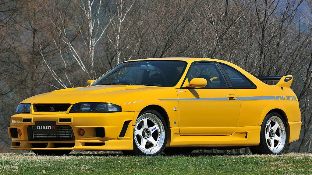 Yellow Nissan Nismo 400R R33 Skyline GT-R parked in winter forest wallpaper background