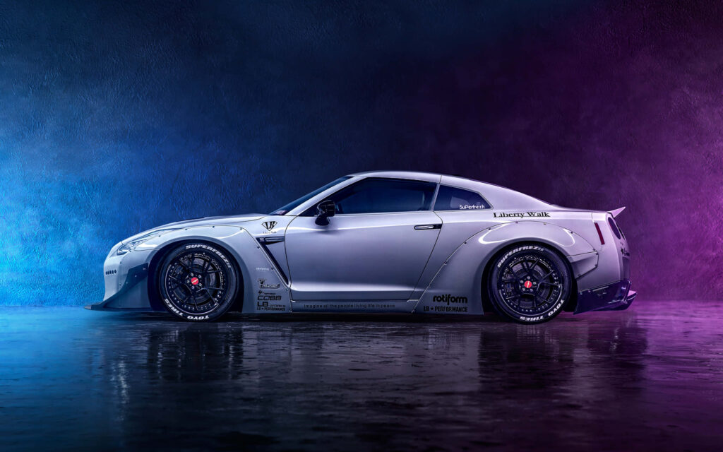 Nissan R35 GTR with Liberty Walk kit under vibrant blue violet smoke on textured backdrop wallpaper
