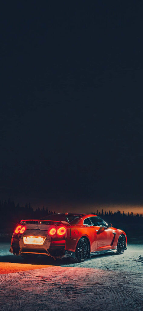 Nissan R35 GTR night wallpaper showcasing sleek design and raw power under dark sky