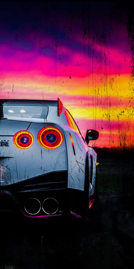 White Nissan R35 GTR rear view with vibrant taillights against dramatic sunset sky wallpaper