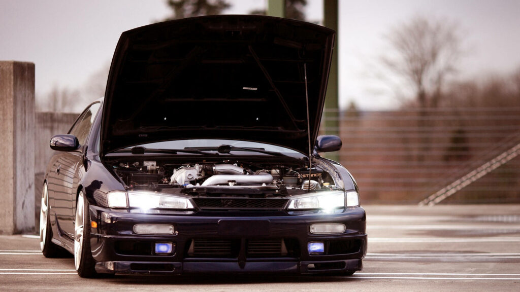 Nissan Silvia S14 front view with open hood showing detailed engine bay in parking lot background Wallpaper