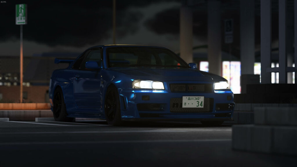 Modified Nissan Skyline GTR R34 in sleek blue under city lights showcasing aggressive design Wallpaper