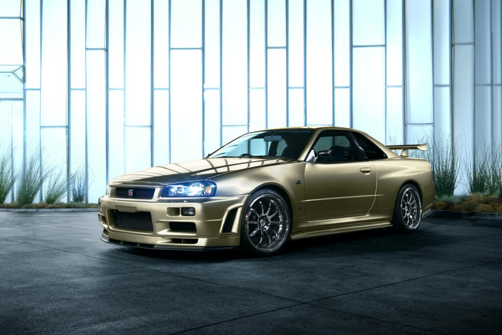 Nissan Skyline R34 in Golden Hue - Striking Side View Wallpaper