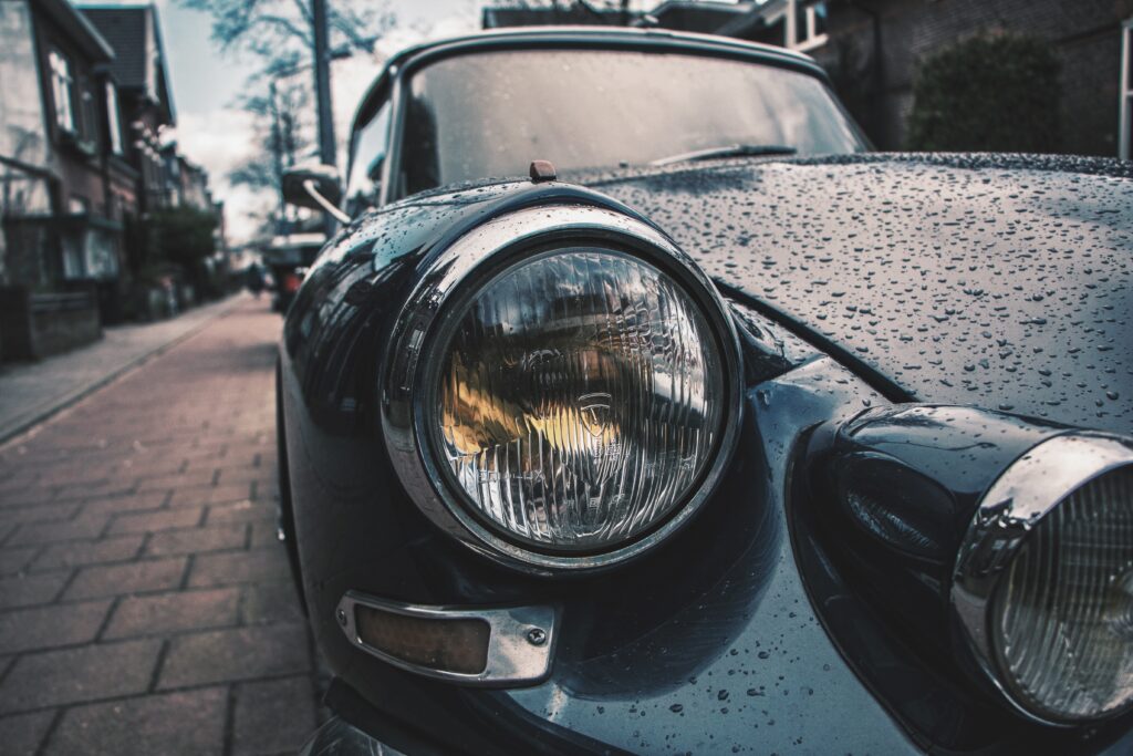Elegant Classic Car Hood: Rainy Day Close-Up Wallpaper