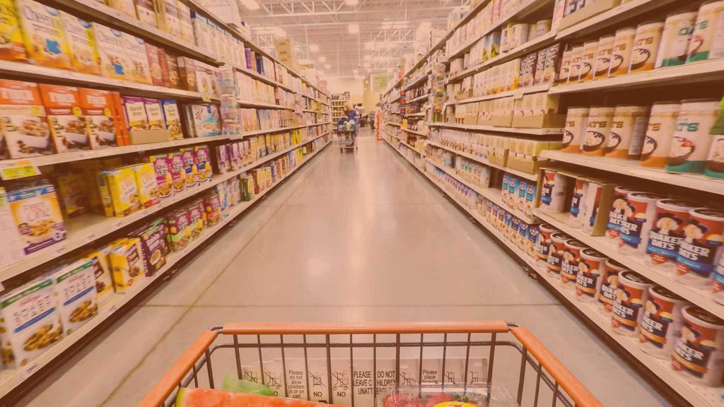 First-person view of grocery aisles with Cheerios Quaker Oats cereals warm orange wallpaper background