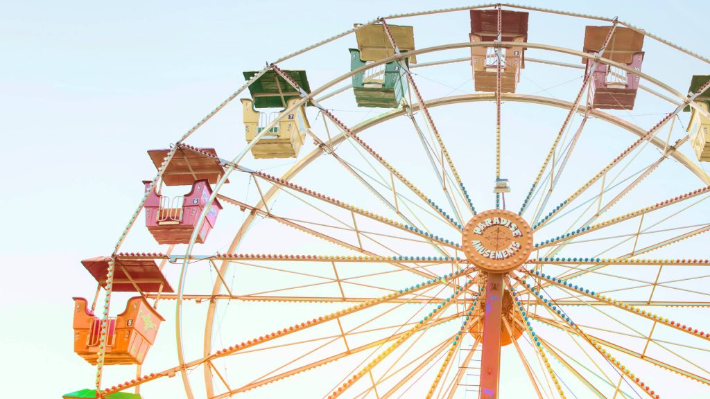 Paradise Amusements Ferris Wheel with colorful cars under bright clear sky carnival wallpaper