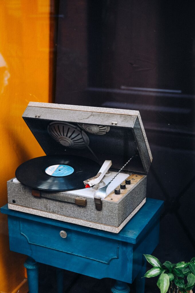 Retro Vinyl Record Player on Blue Table – Nostalgic Wallpaper
