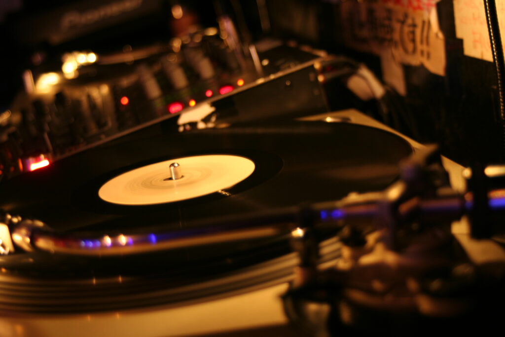 Warm Nostalgia: Close-Up Vinyl Disc Turntable Wallpaper Background