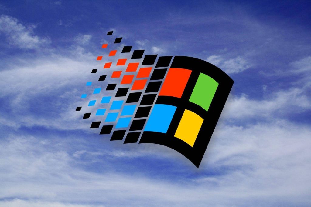 Windows 98 wallpaper with colorful waving logo on bright blue cloudy sky retro 90s design