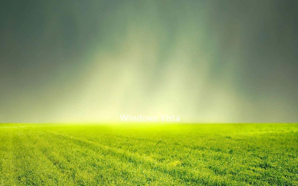 Windows Vista style wallpaper showing vibrant green field with glowing horizon digital landscape
